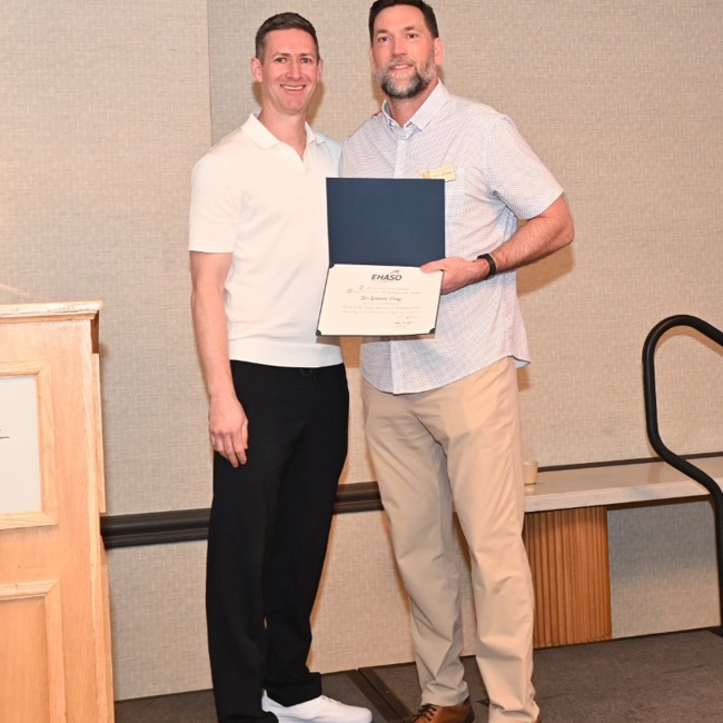 dr hartman presenting dr jones with his membership certificate