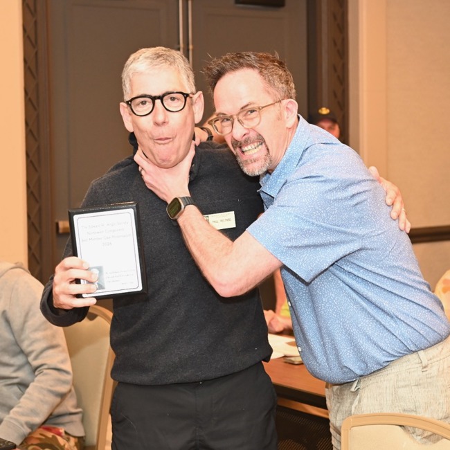 dr paul helpard accepting the award for best member case